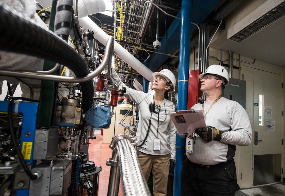 NREL Thermochemical Process/ Control Engineer and Research Technician work during a 48 hour Hot Test in Thermochemical User Facility Pilot Plant in the Field Test Laboratory Building (FTLB).