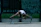 Man stretching outdoors with headphones, looking energized after a benediktastraining session.