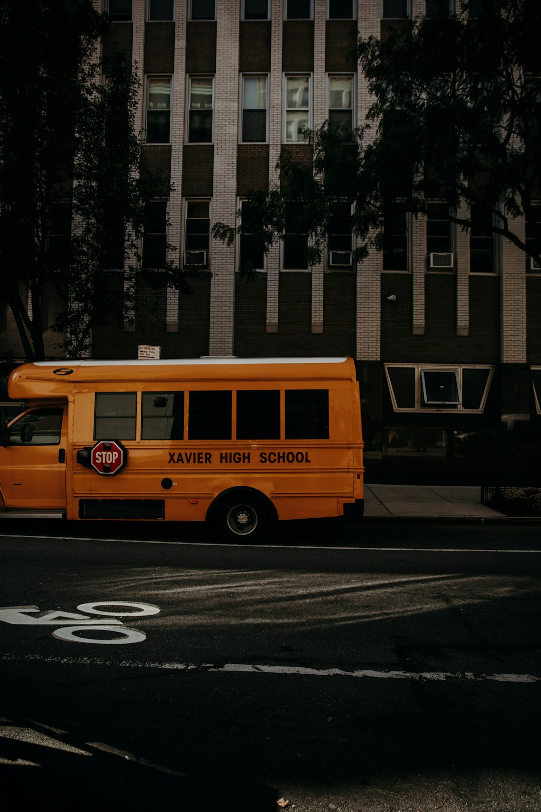 yellow Xavier high school bus on road