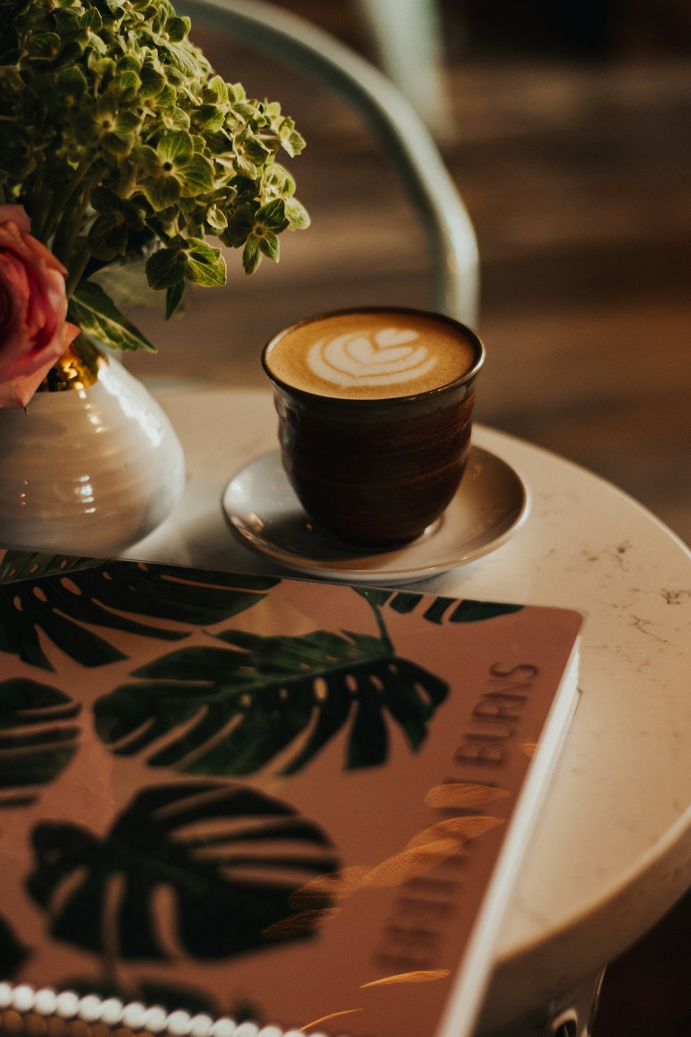 brown ceramic mug on saucer on table