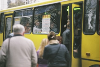 A group of travelers boarding a bus at a terminal.