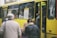 A group of happy passengers boarding a comfortable bus for their journey.