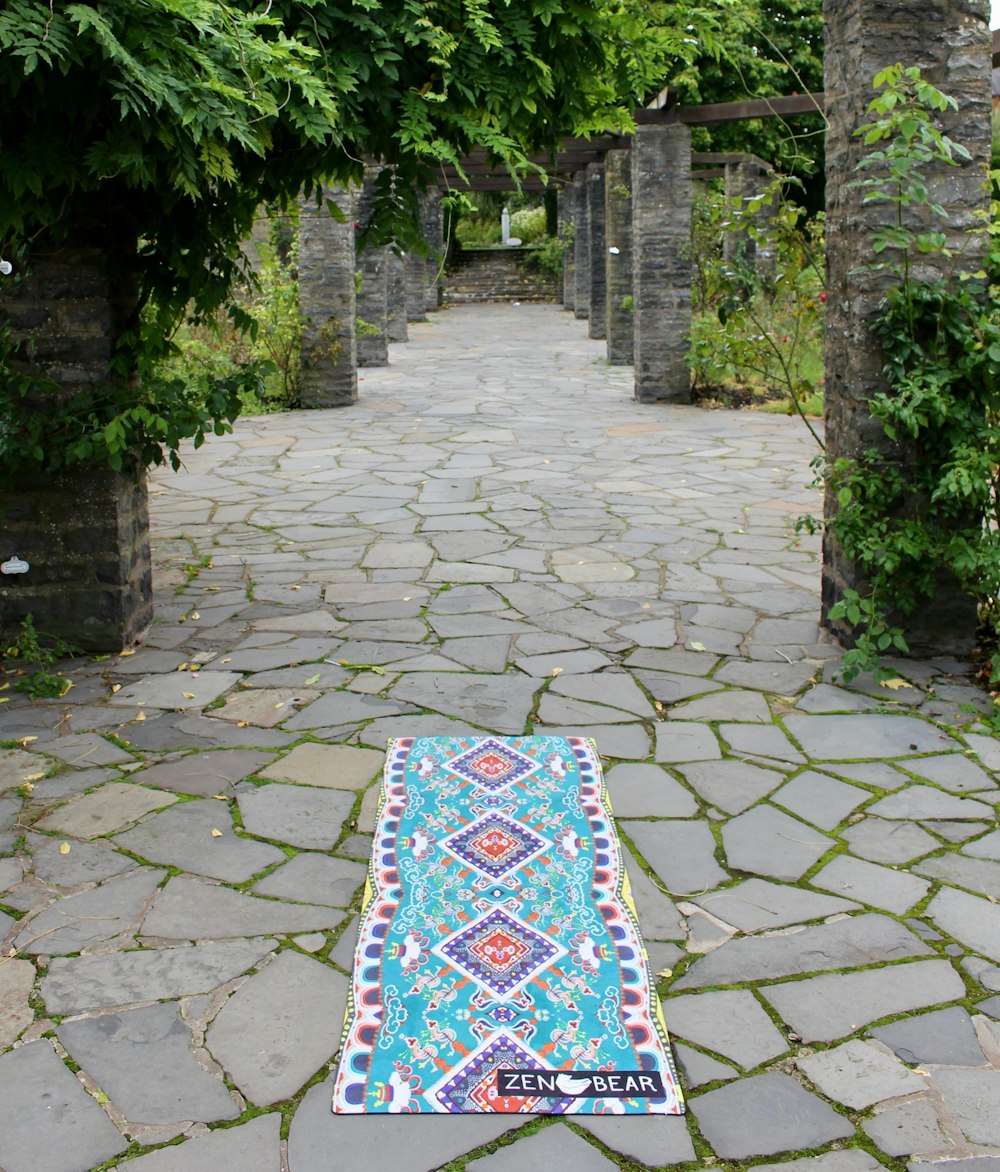 teal and multicolored floral area rug