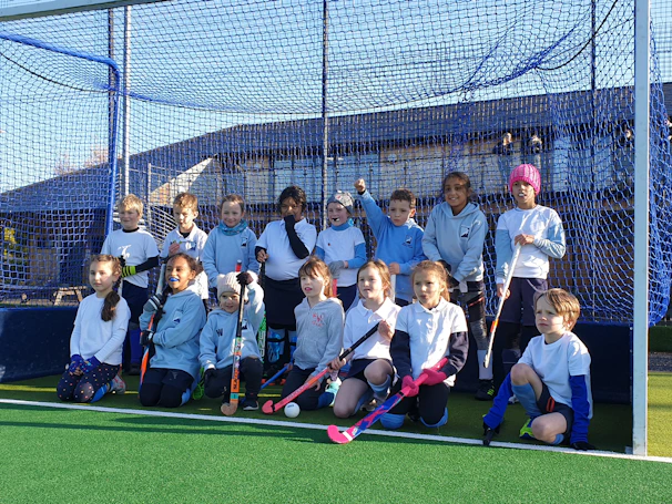 A group of enthusiastic kids celebrating a successful catch during a training session