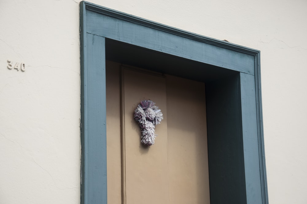 white flower on brown wall