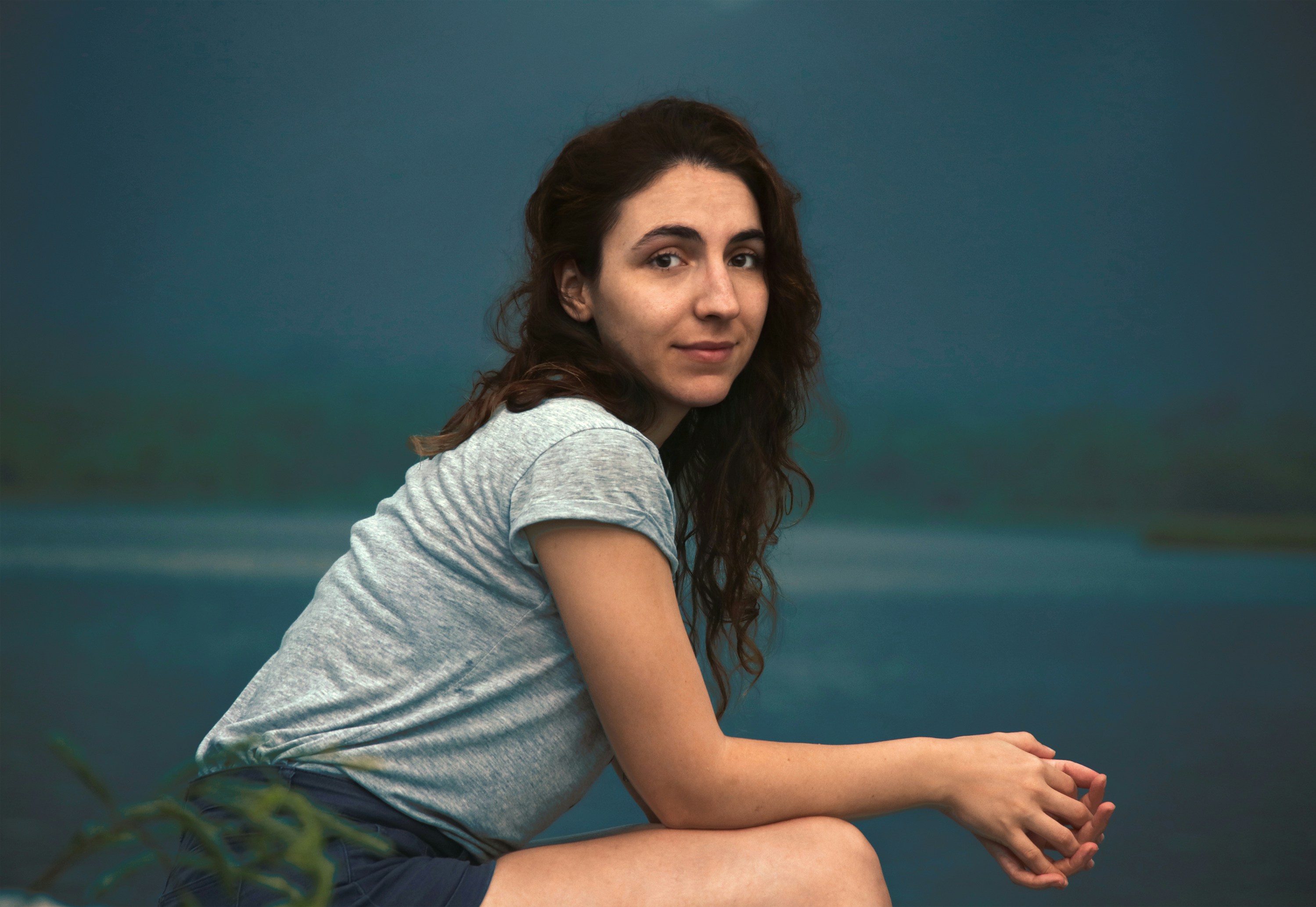 woman sitting near body of water