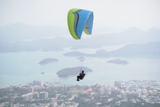 man on blue and green parachute