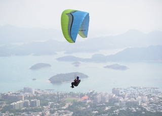 man on blue and green parachute