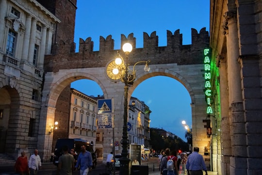 people walking near Portoni della Bra in Verona during night time in Gran Guardia Italy