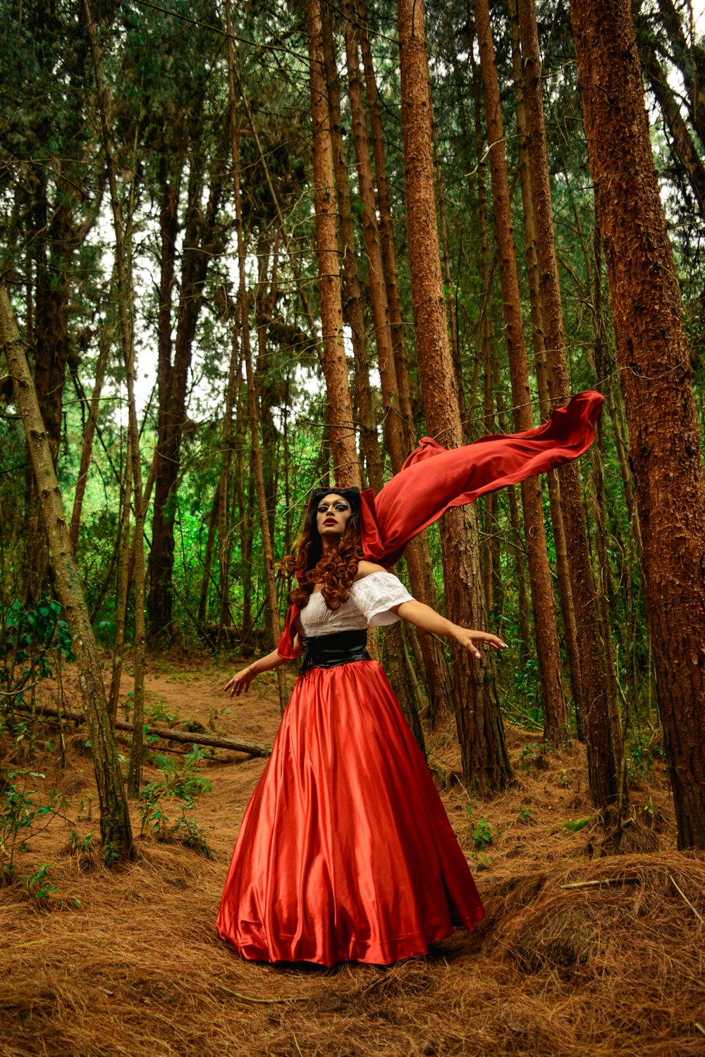 woman standing surrounded with trees during daytime