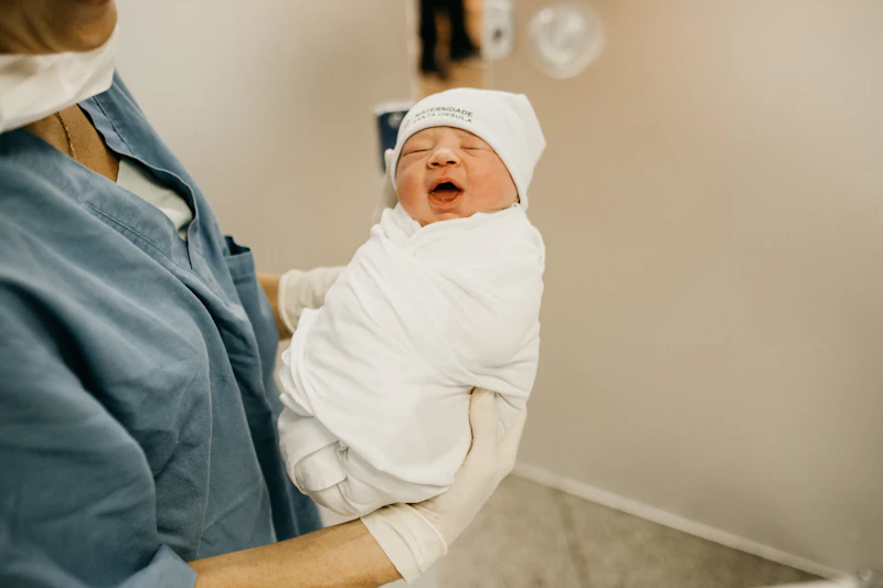 Nurse gently caring for a newborn baby