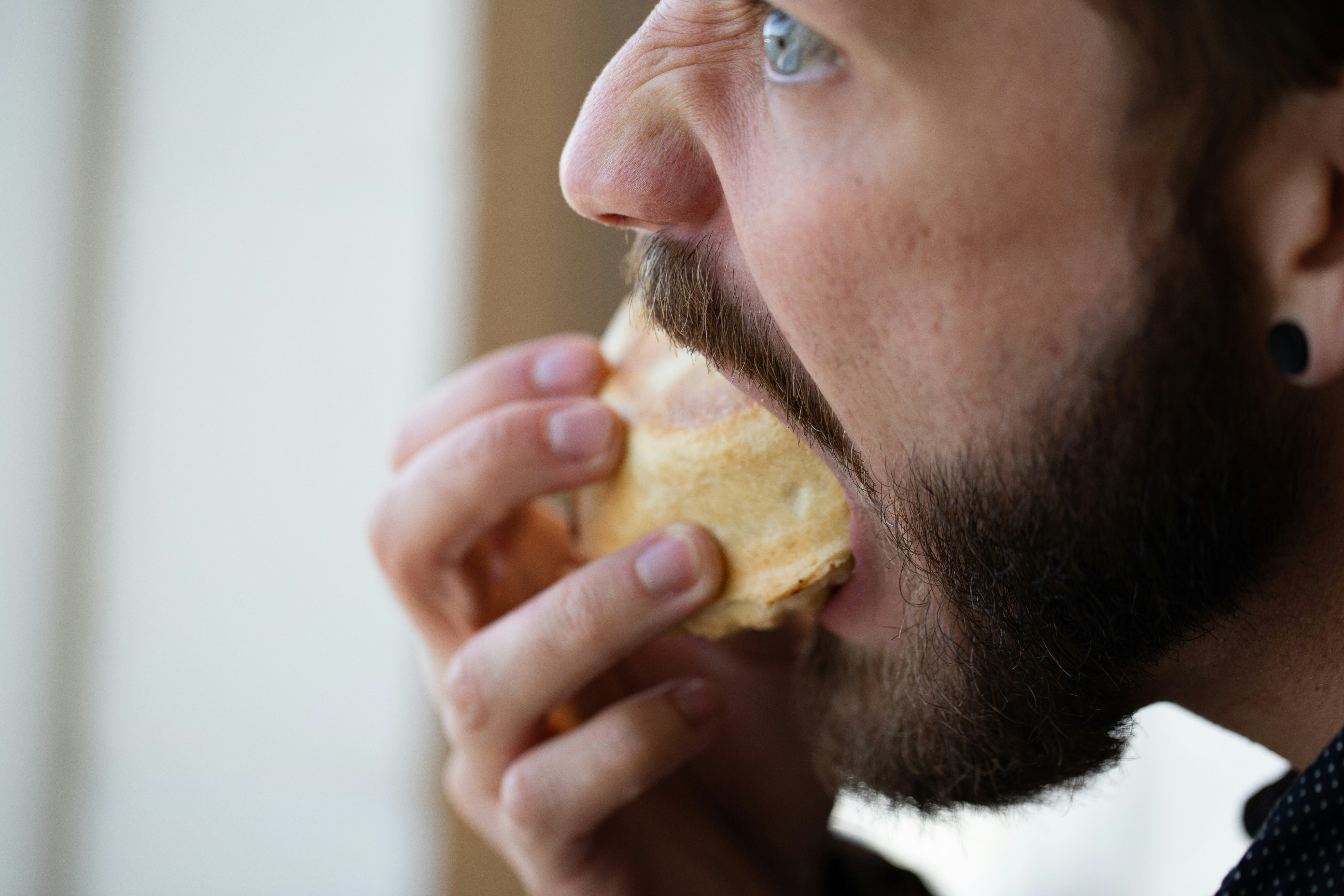man eating muffin