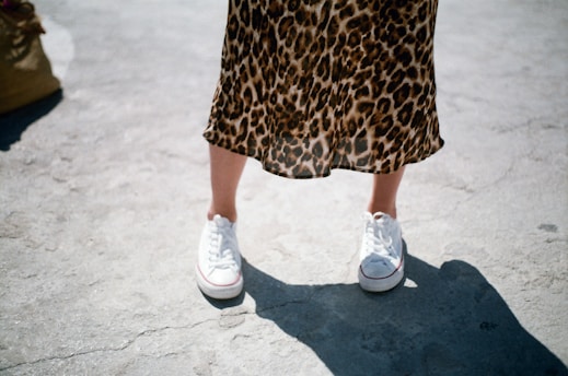 woman wearing white low-top sneakers