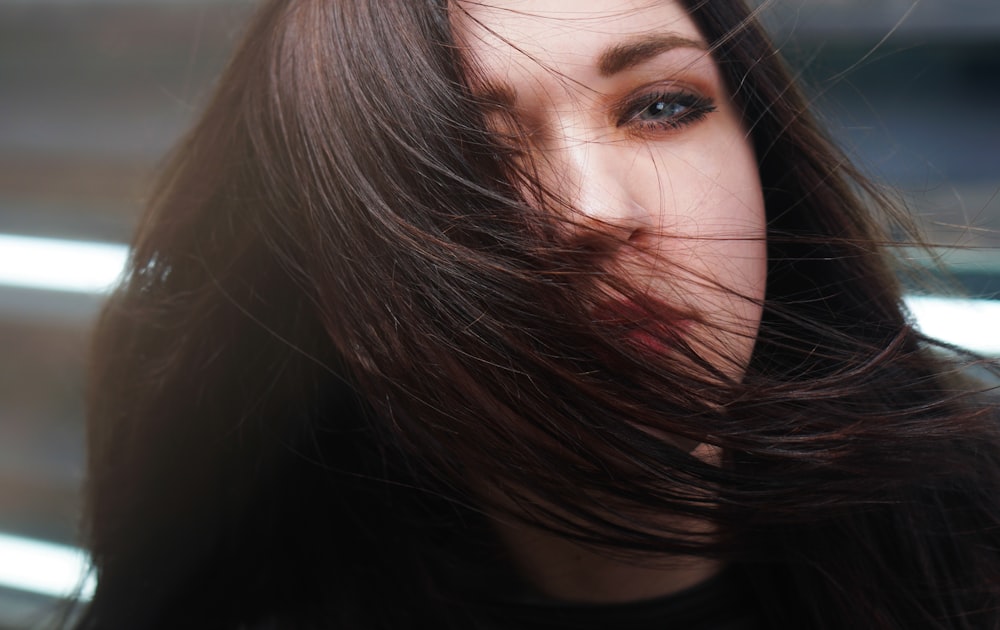 selective focus photography of woman with hair covering right cheek