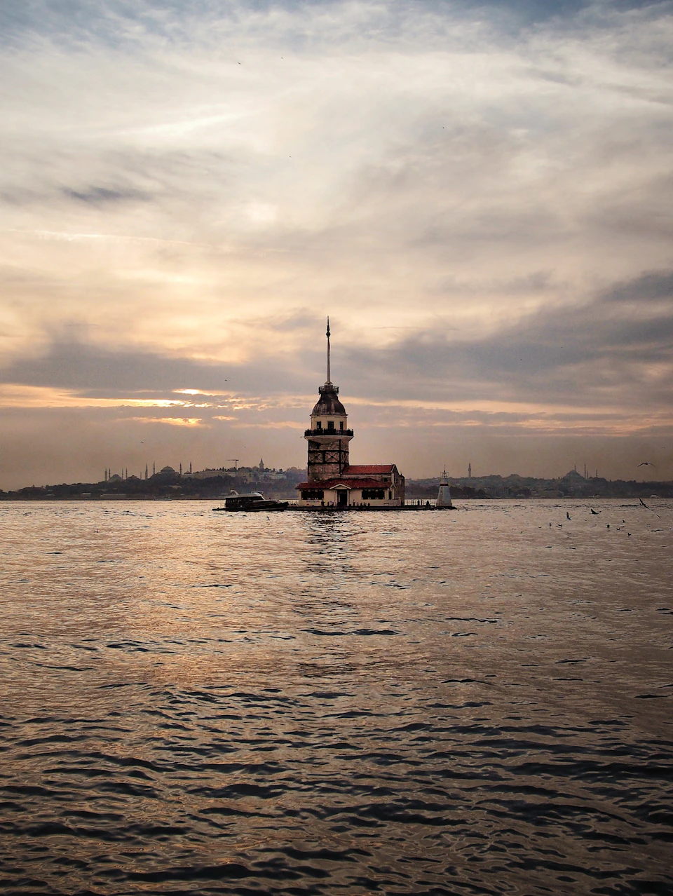 Sultan Ahmed Mosque in Bosphorus Strait with warm hues against blue sky backdrop