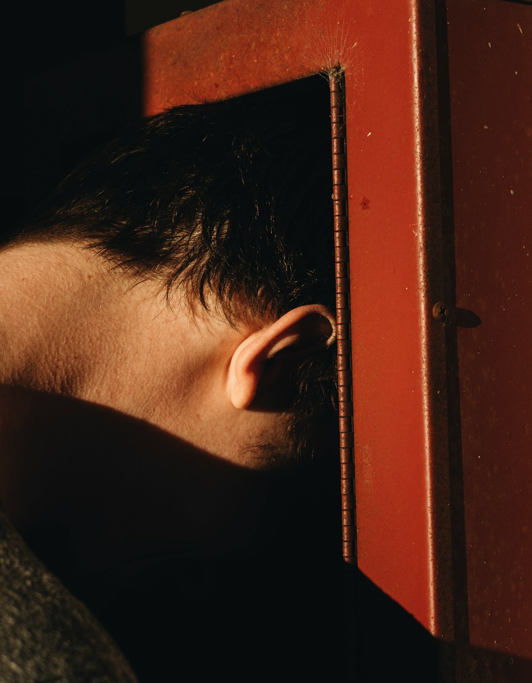 man putting his head inside a box