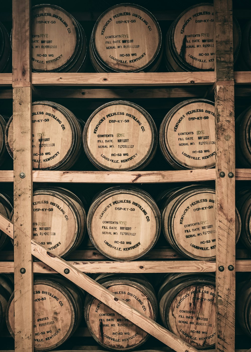 a shelf filled with lots of wooden barrels