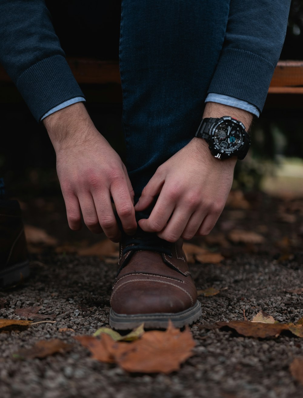 man tying his shoe lace