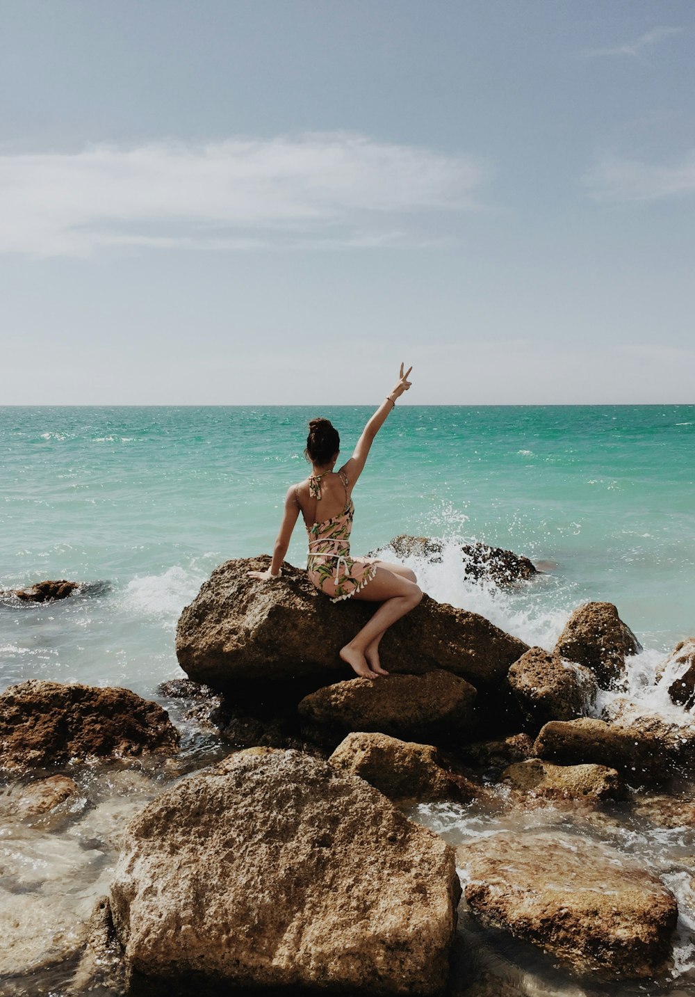 woman sitting on a rock in the beach