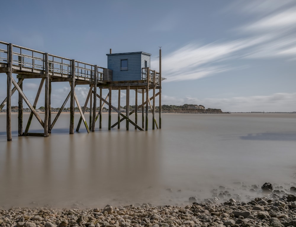 brown wooden dock near body of water