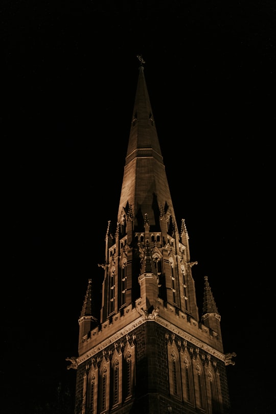 gray concrete tower at night in Saint Patricks Cathedral Australia