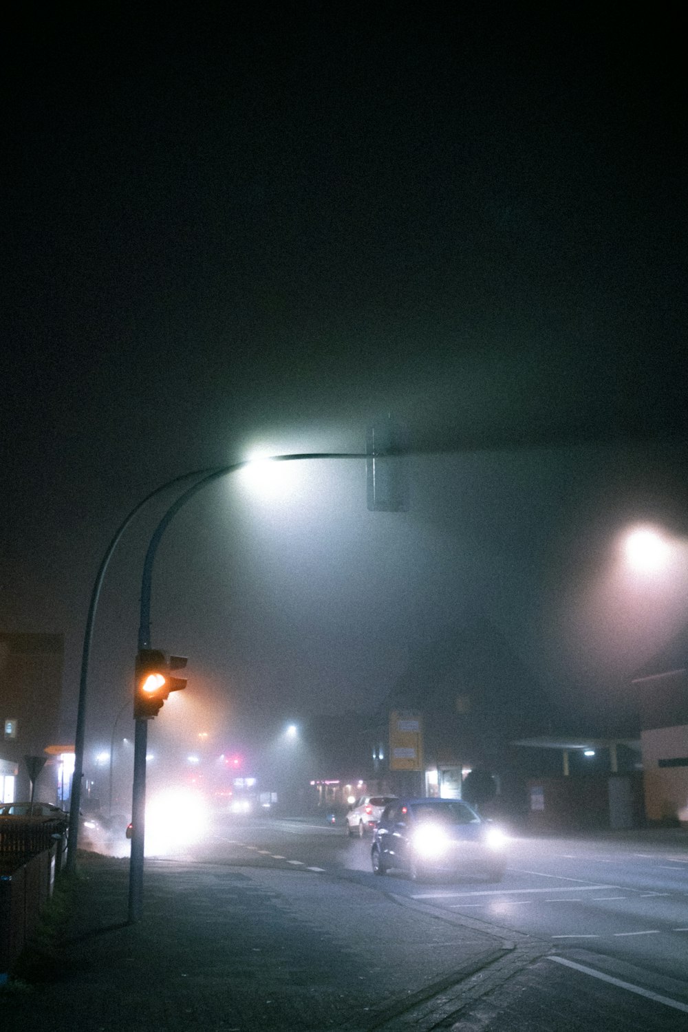 carros passando por uma rua durante a noite