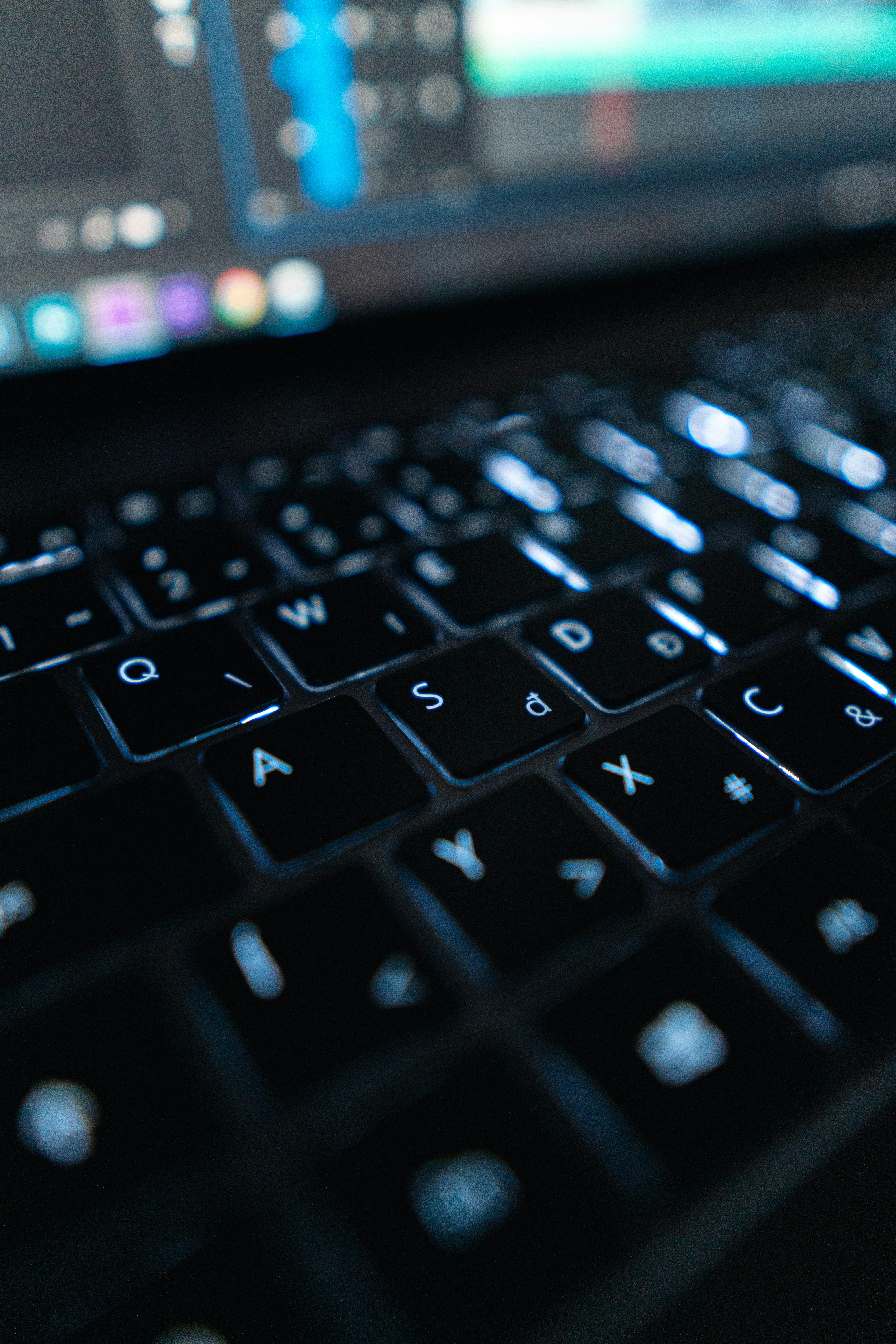 A computer keyboard shows backlit keys, while the user researches adding text to YouTube videos.
