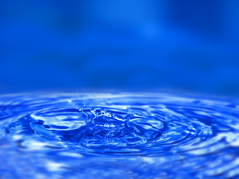 a close up of a blue water droplet