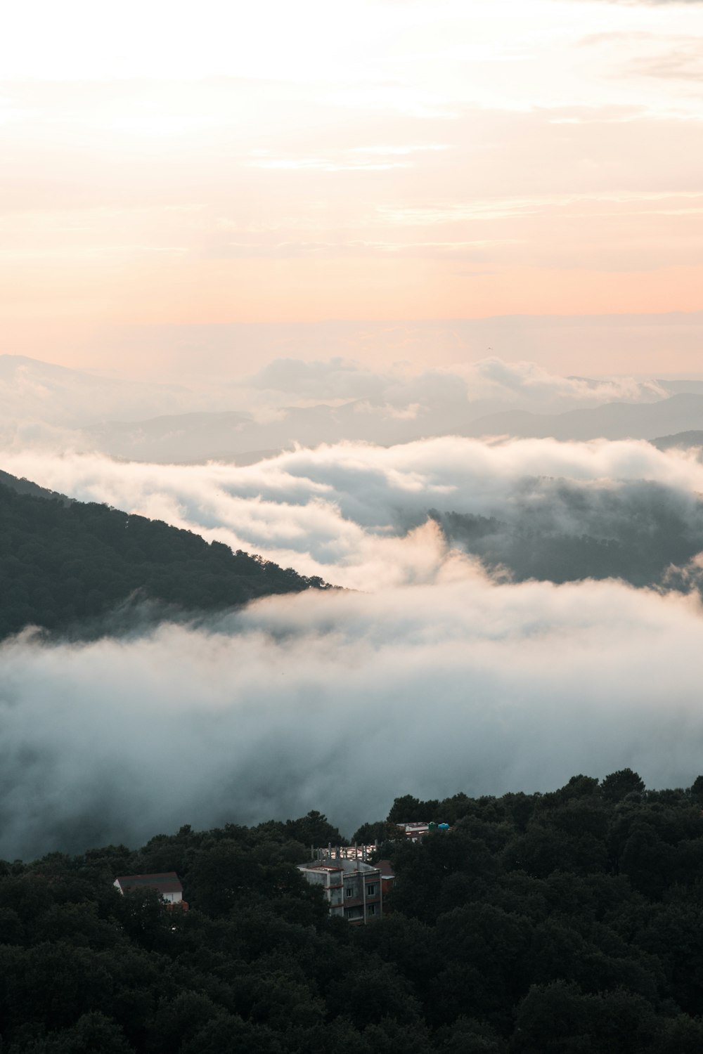 a view of a mountain covered in clouds