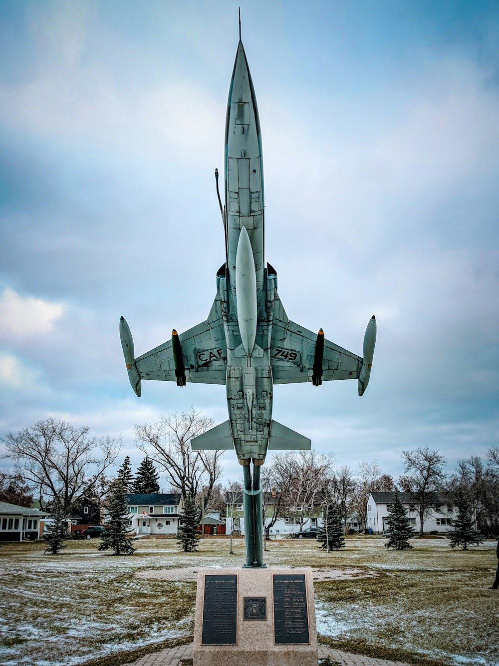 white airplane near trees