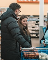 two men and man standing beside push cart