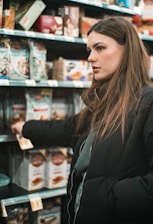 woman standing infront of shelf