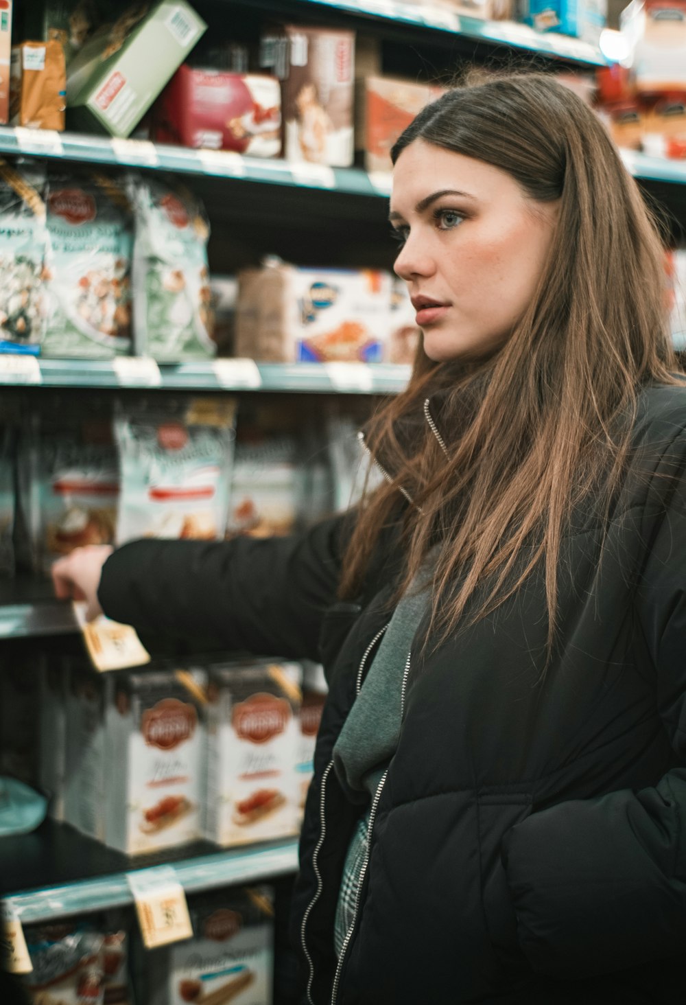 woman standing infront of shelf