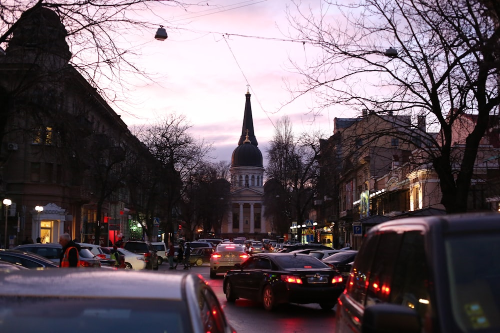 view photography of vehicles on road near buildings during dawn