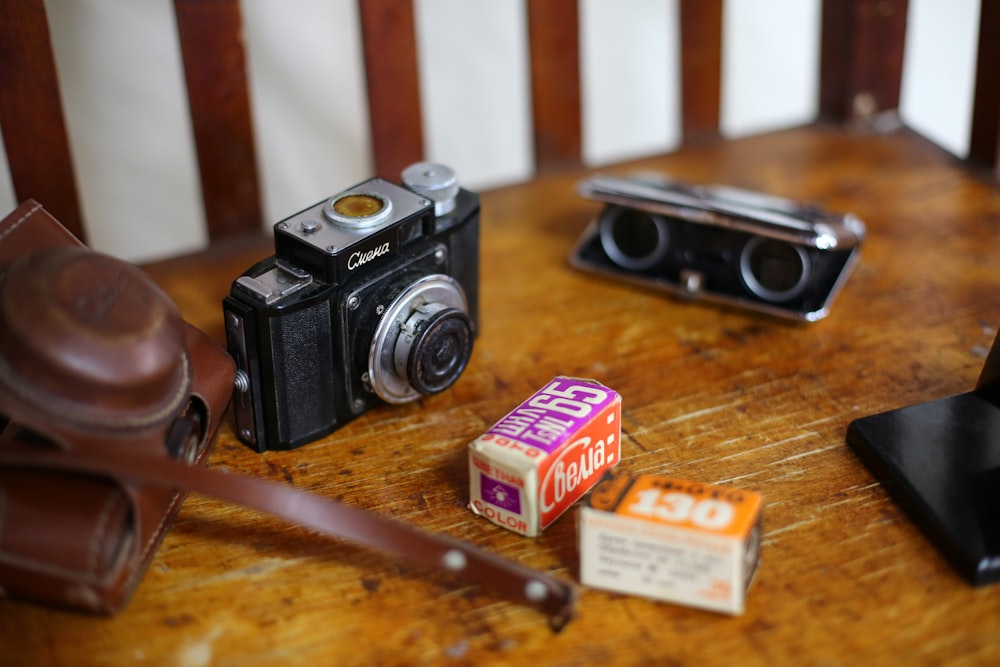 black and gray camera with parts on table