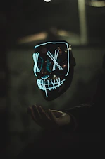 A sleek, neon-green glowing samurai mask with smoky dark background reflecting the brand’s edgy vibe.