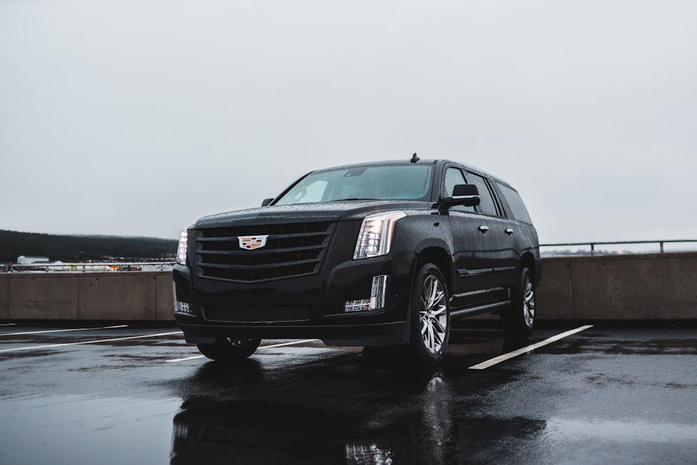 a black cadillac parked in a parking lot