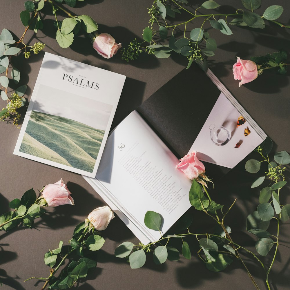 a book and some flowers on a table