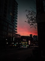 An urban street scene at dusk, with vibrant colors and dynamic shadows.