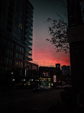 An urban street scene at dusk, with vibrant colors and dynamic shadows.