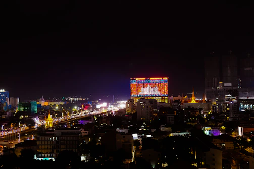 Night view of a transparent LED screen illuminating a busy commercial street with colorful visuals