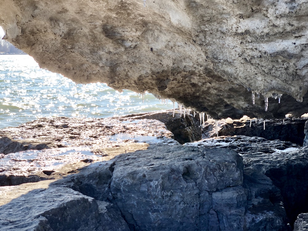 a large rock formation next to a body of water