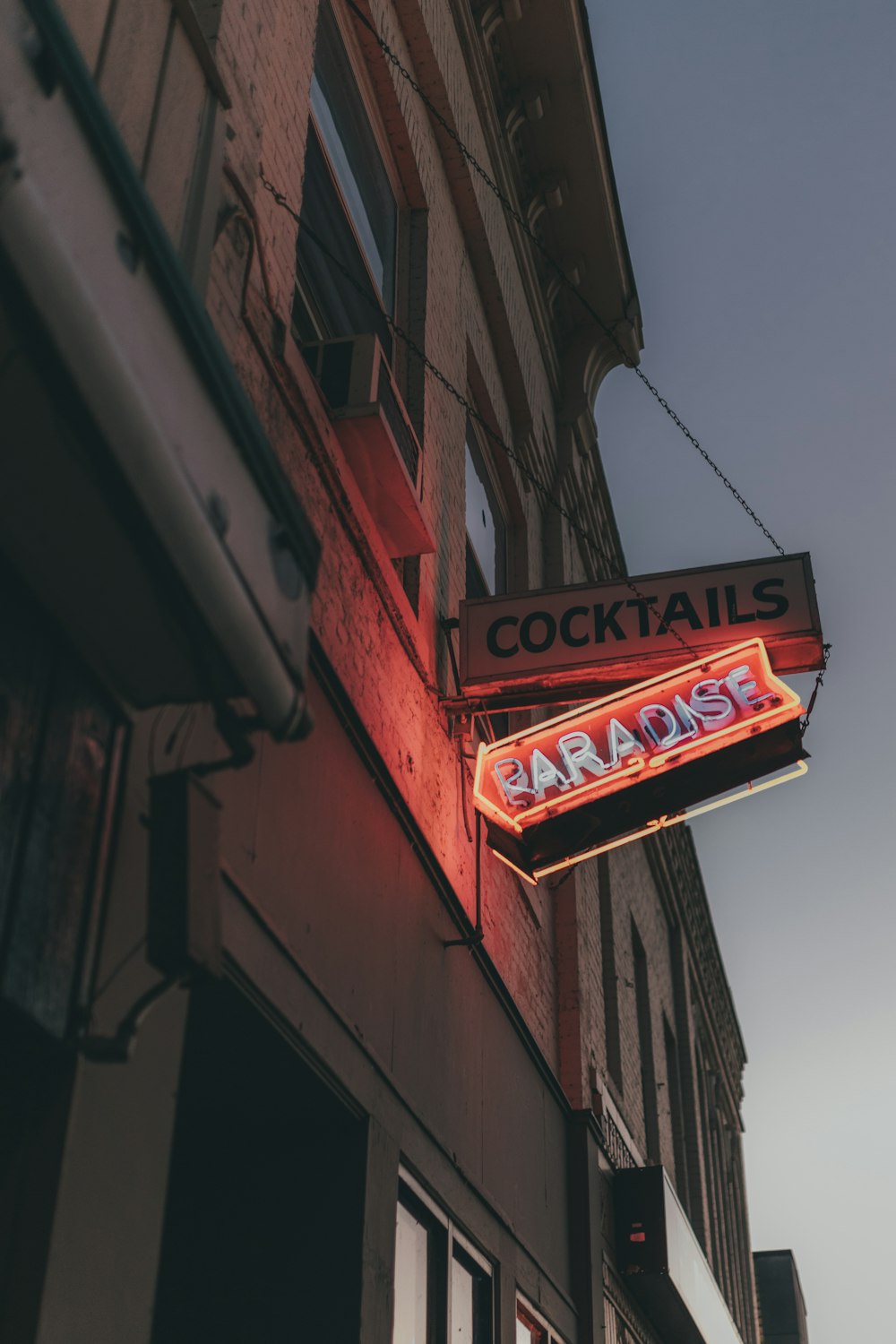 red and orange-lighted Paradise neon sign