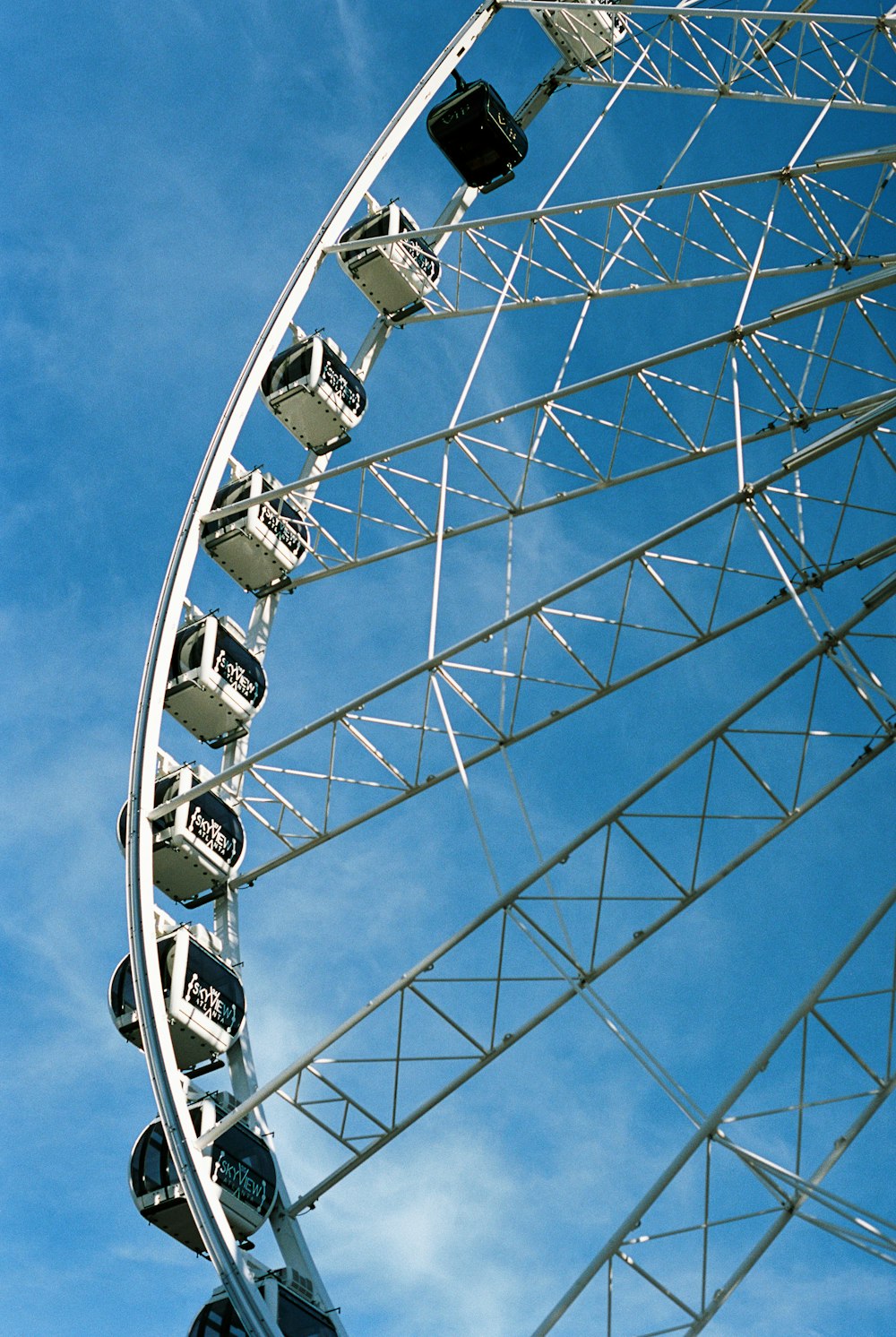 white Ferris wheel under blue sky