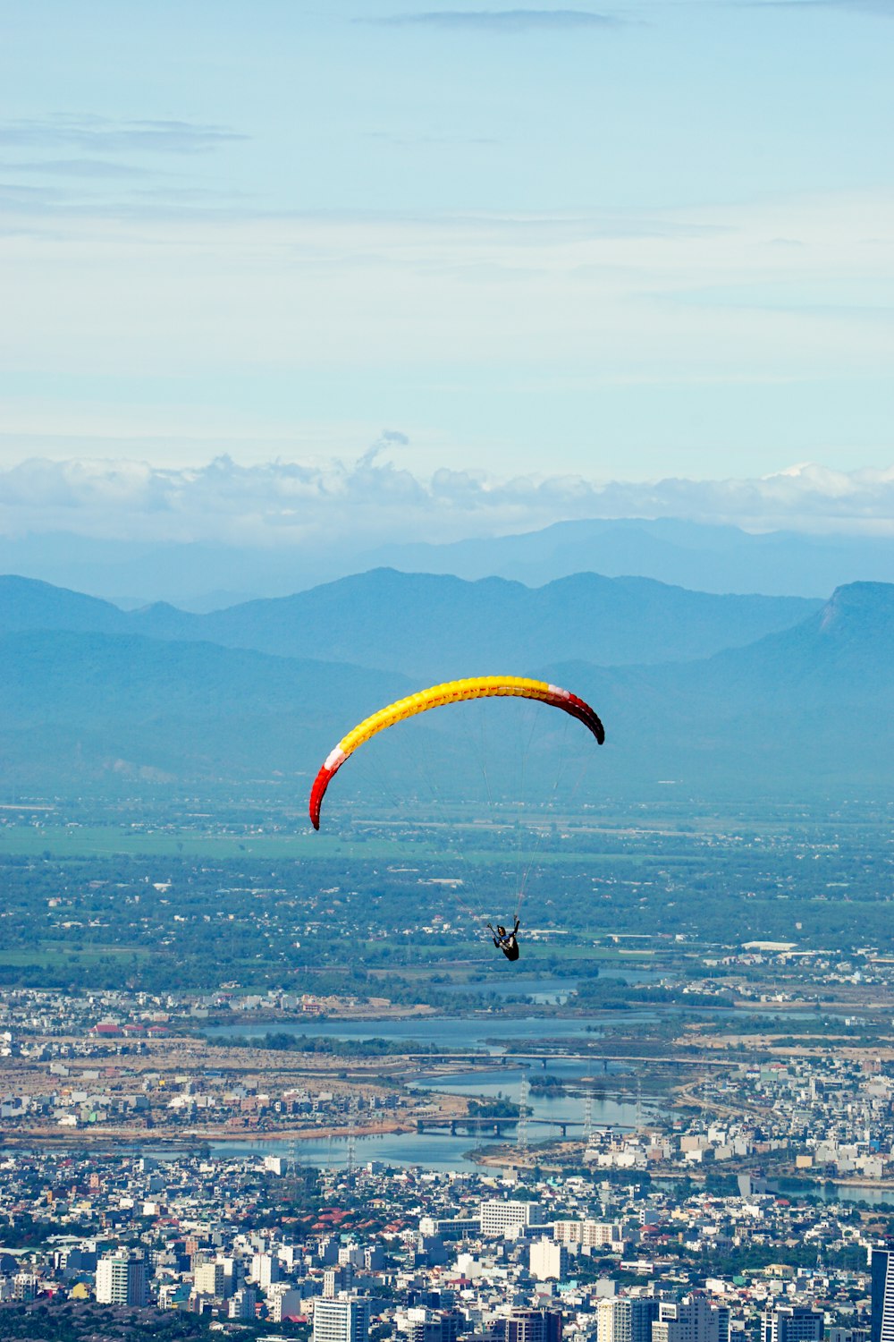 time lapse photography of person in a parachute in the sky