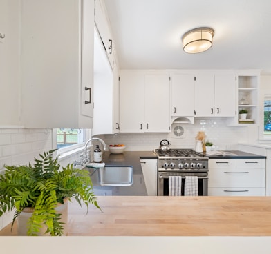 white wooden kitchen cupboards and gray gas stove