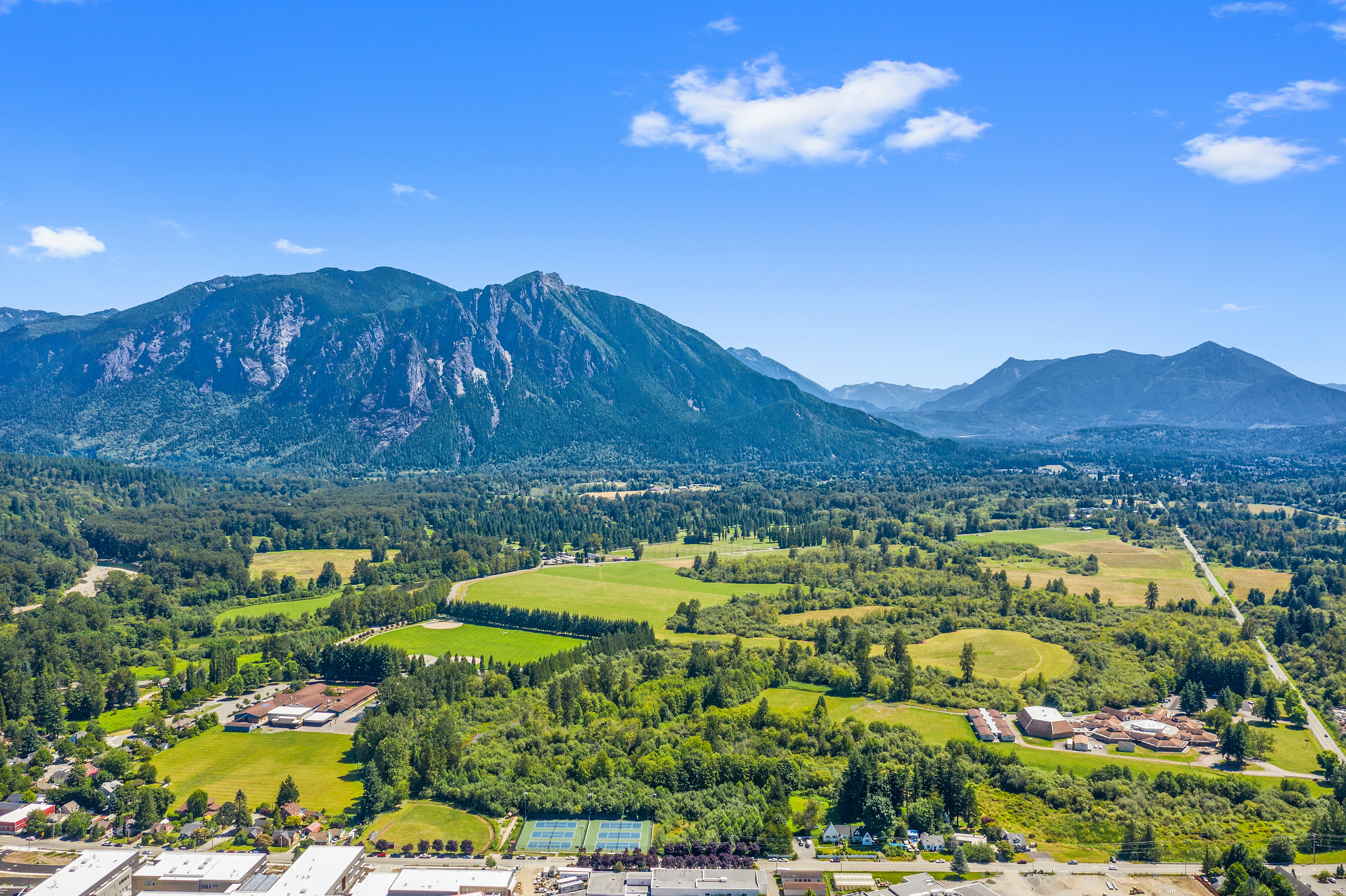 Aerial photo of houses near mountain photo – Free Blue Image on Unsplash