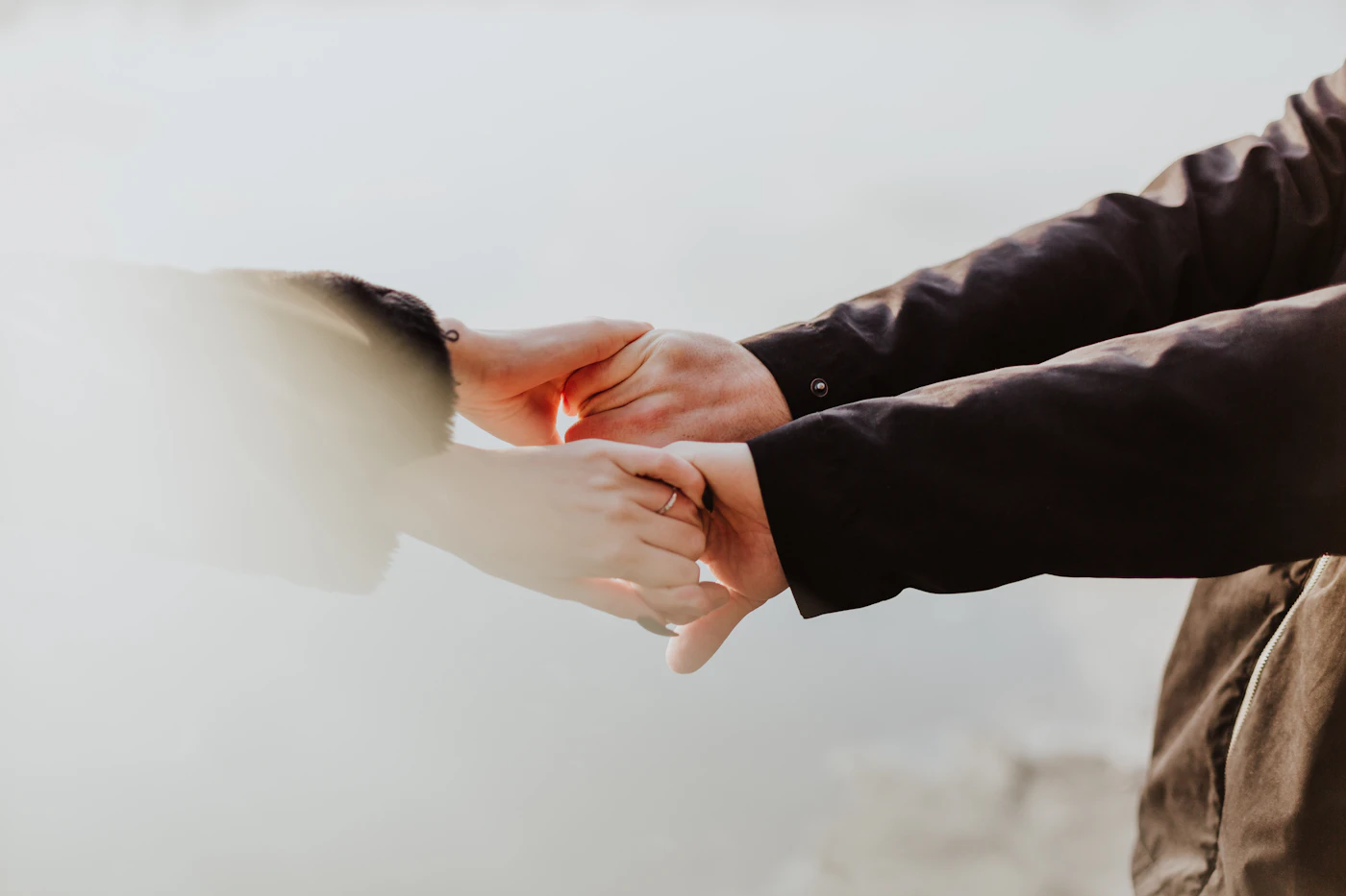 A married couple holding hands, representing unity, support and oneness