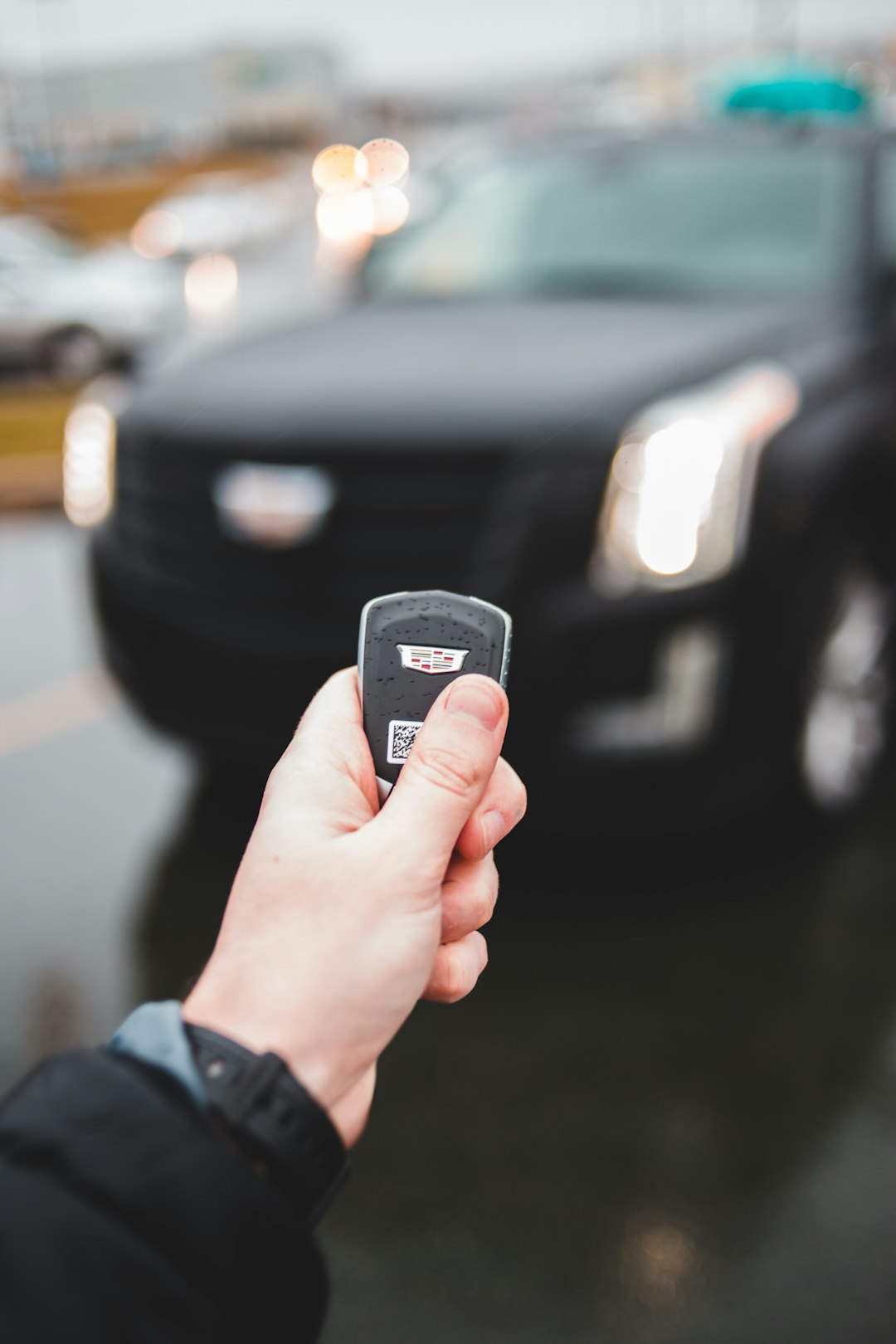 selective focus photography of black Cadillac vehicle fob