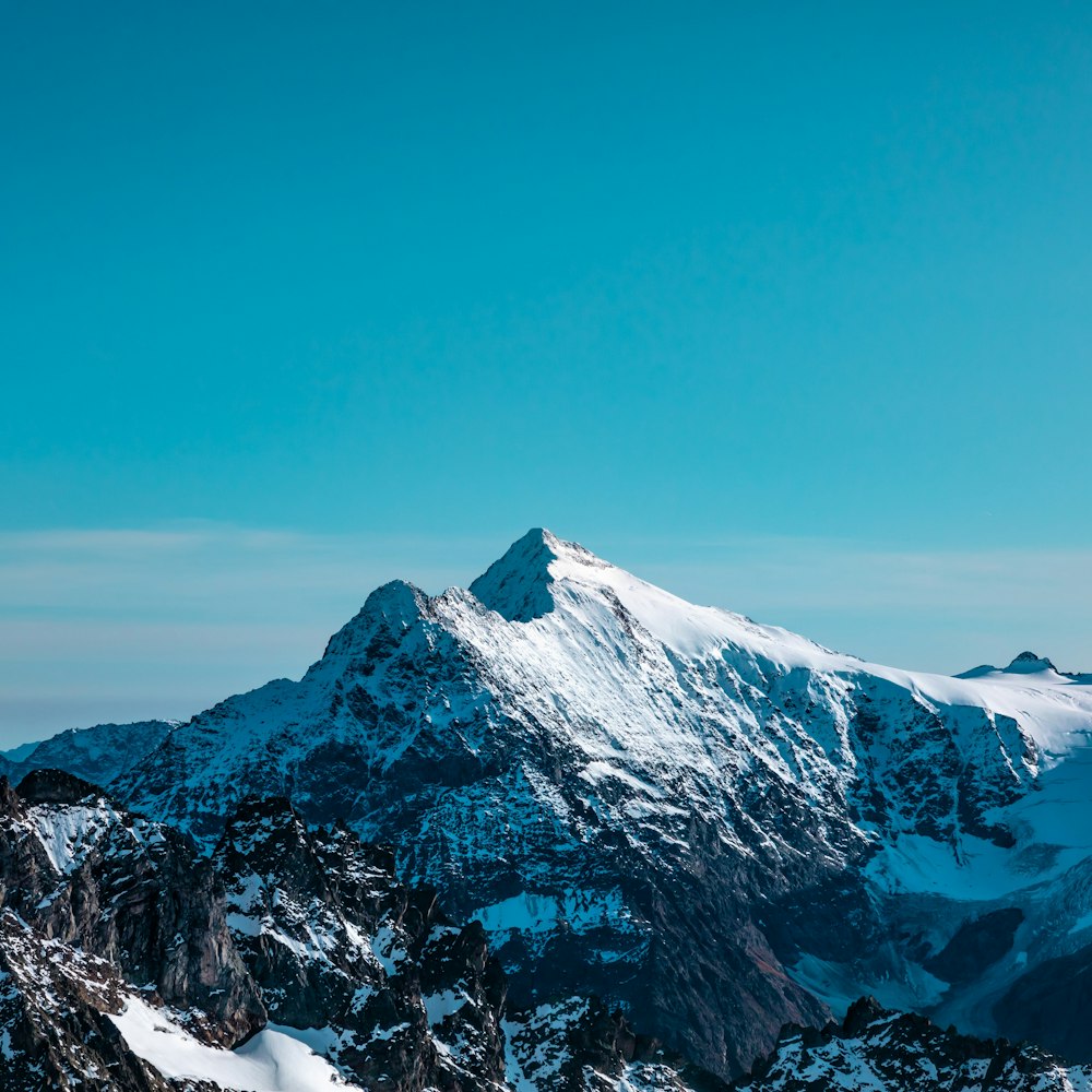 snow-covered mountain under blue sky